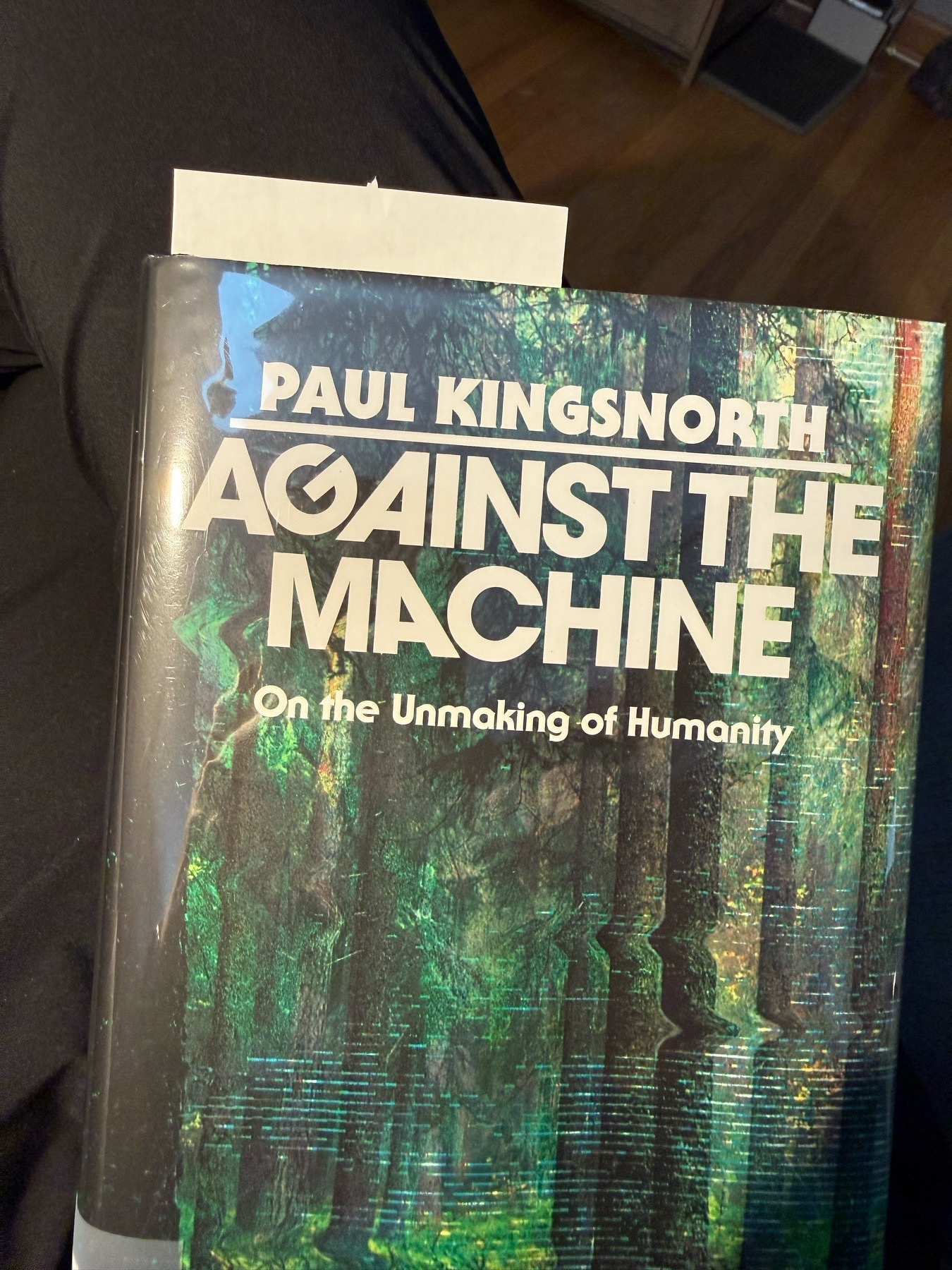 Cover of a book with a distorted picture of trees on the cover. Paul Kingsnorth, author. Against the machine: on the unmaking of humanity 